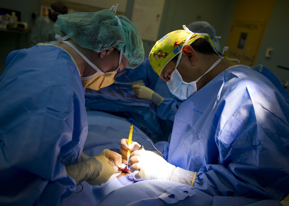 Surgeons performing surgery while making an incision